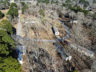 Serene mobile home community with well-maintained grounds, spacious lots, and a quiet country atmosphere just minutes...