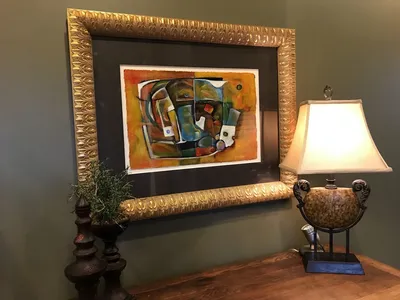 Bright art gallery space displaying Frank Kelley Jr's detailed paintings with multiple works-in-progress visible in the...