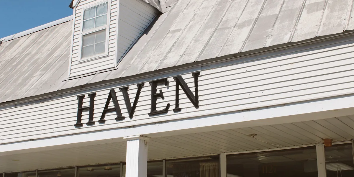 Thoughtfully arranged gift shop with elegant displays of home decor and gift items in neutral tones, featuring...