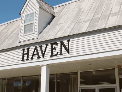 Thoughtfully arranged gift shop with elegant displays of home decor and gift items in neutral tones, featuring...