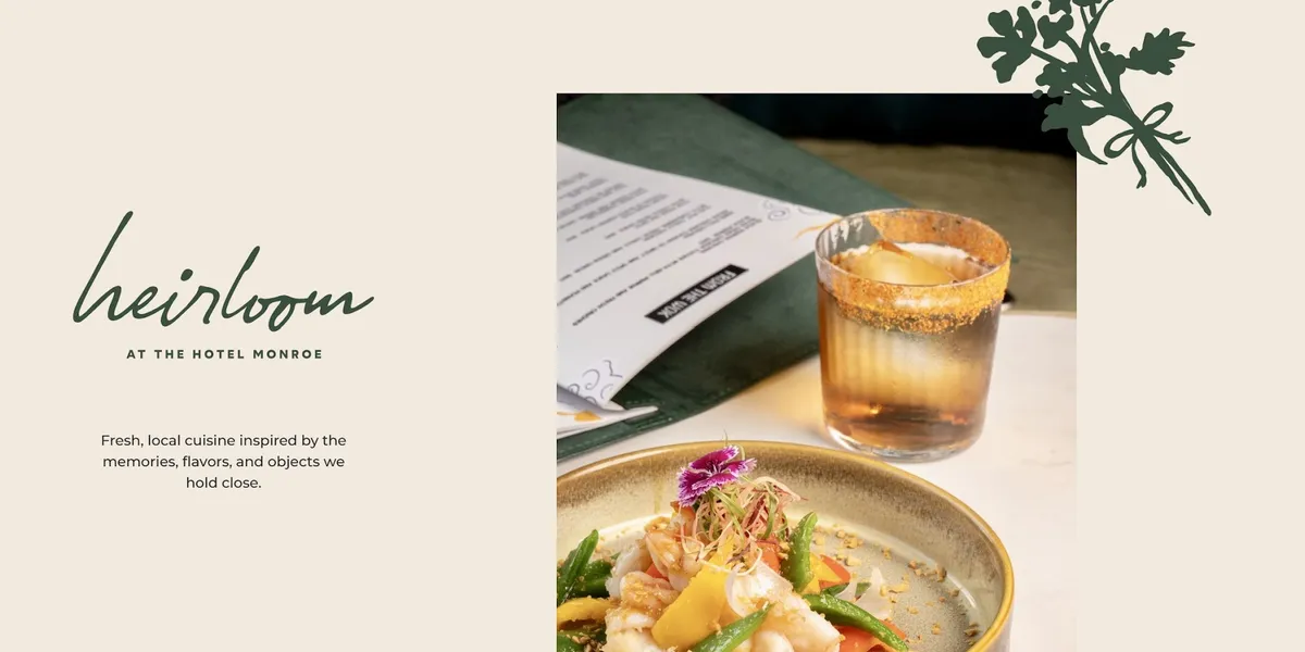 Elegant dining space in Heirloom Restaurant with festive decor, white tablecloths, and boutique hotel ambiance in...