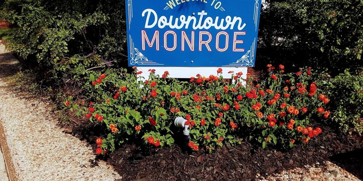 A clean, compact green space in downtown Monroe with open areas for pets and families, featuring basic park amenities...
