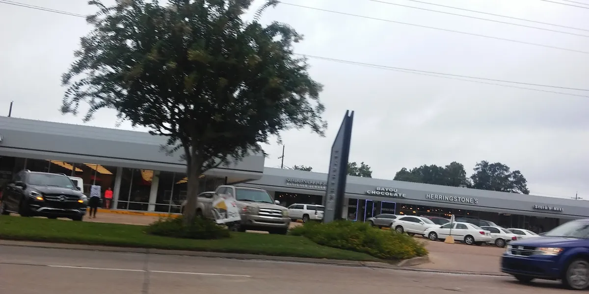 Elegant women's boutique with neatly arranged clothing displays, accessory showcases, and a sophisticated shopping...