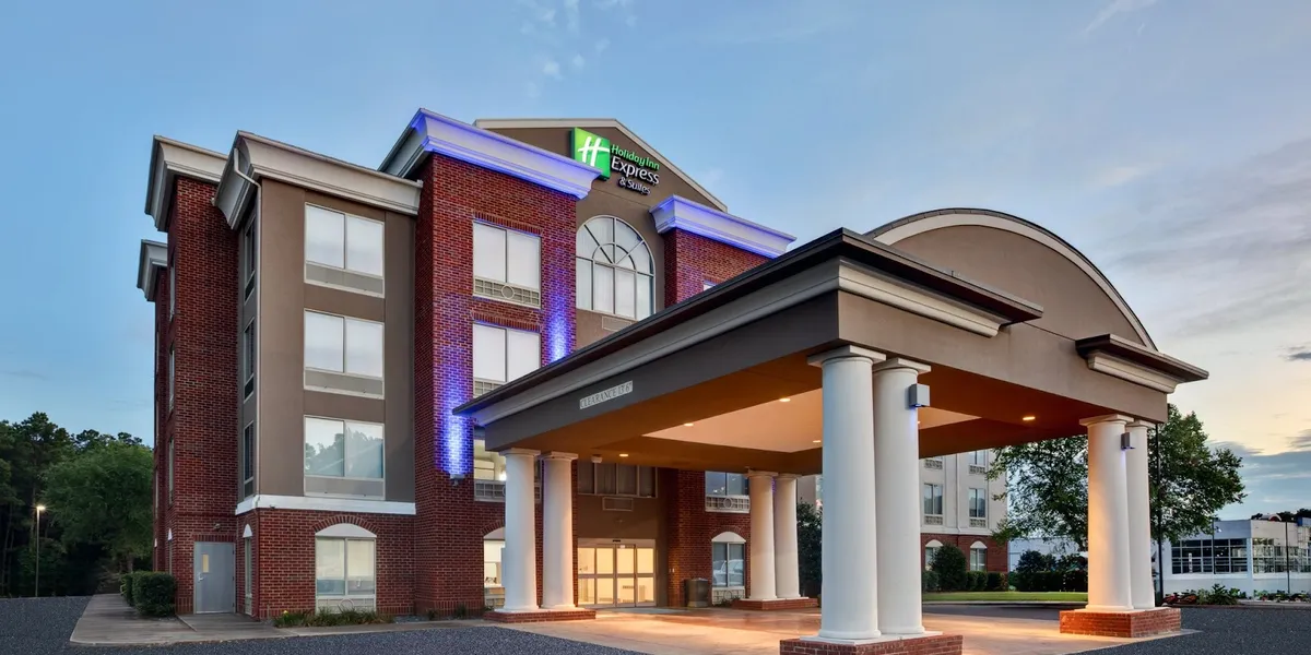 Modern Holiday Inn Express lobby with check-in counter, comfortable seating areas, and professional atmosphere catering...