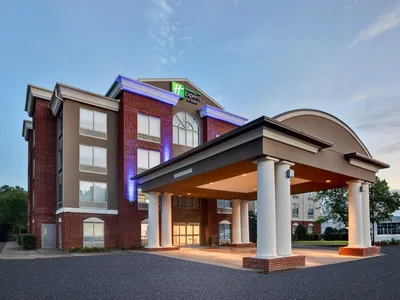 Modern Holiday Inn Express lobby with check-in counter, comfortable seating areas, and professional atmosphere catering...