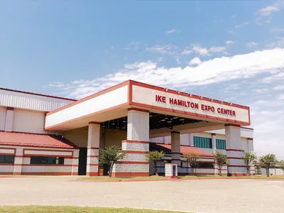 Spacious exposition center with attached stalls and arena setup, featuring convenient facilities and hotel access on the...