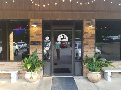 Casual Mexican restaurant interior with table seating, colorful decor, and bar area serving their signature coconut...