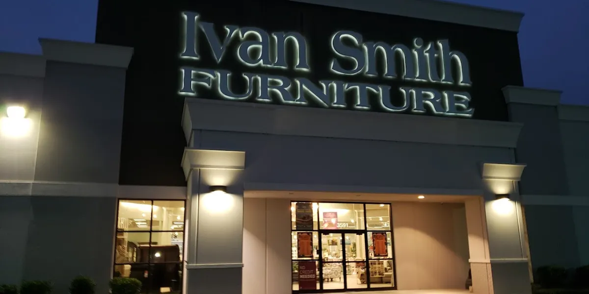 Spacious furniture showroom with casual browsing atmosphere and extensive inventory displays arranged in lifestyle sections.