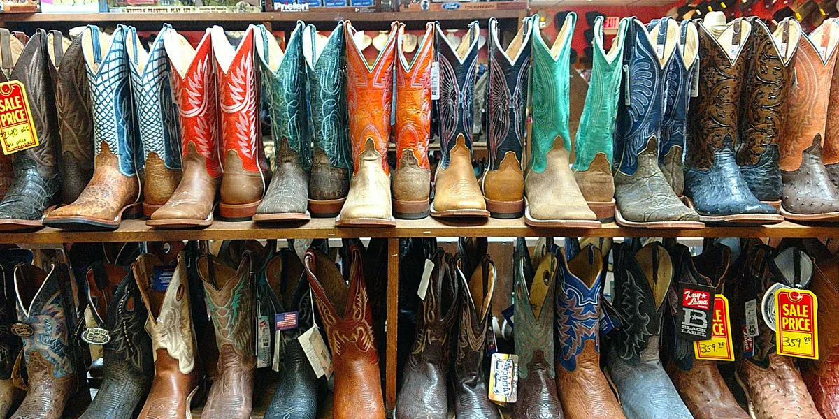 Spacious Western wear store with organized displays of colorful boots, hats, and jeans, featuring both urban and...