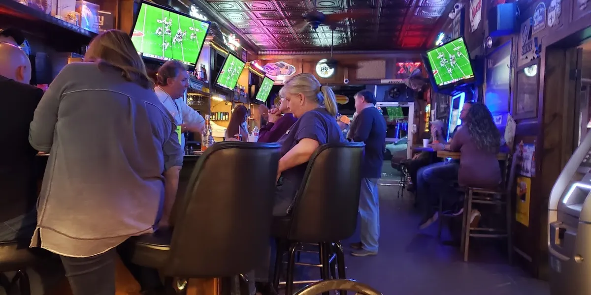 Small, intimate bar with outdoor back patio seating where locals gather to watch football games in a cozy, familiar...