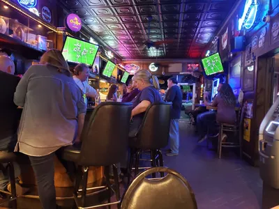 Small, intimate bar with outdoor back patio seating where locals gather to watch football games in a cozy, familiar...