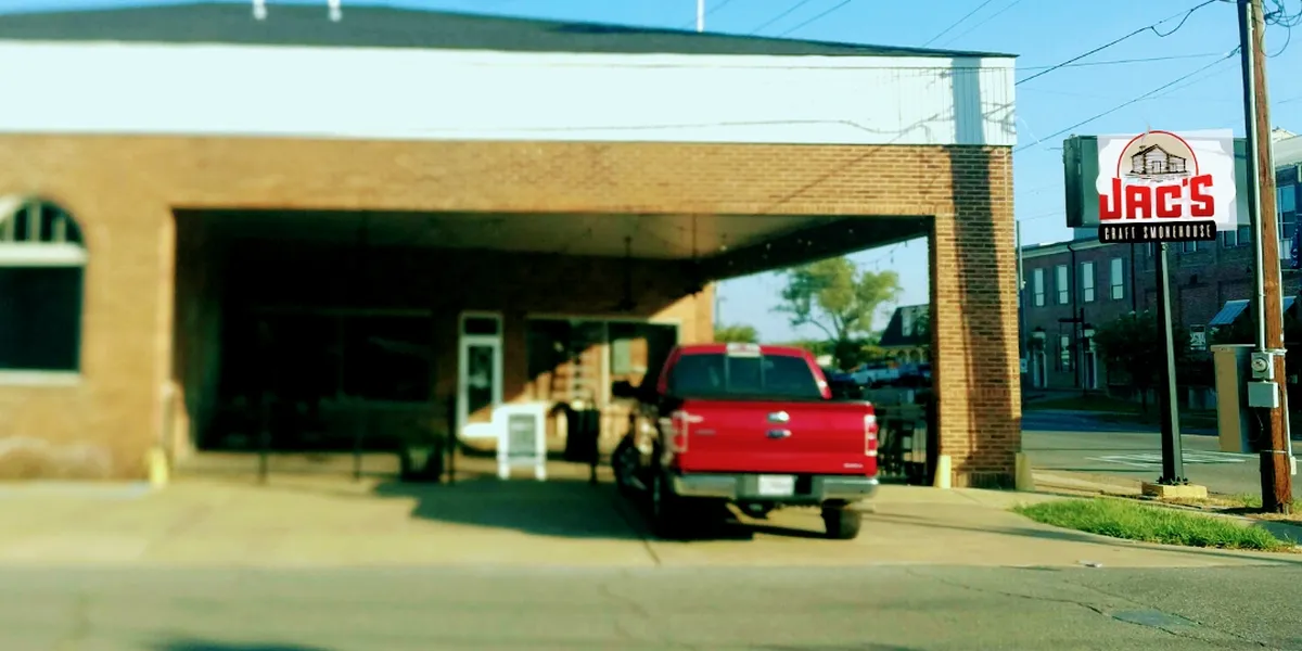 Clean barbecue restaurant with indoor and outdoor seating areas, featuring wood accents and a relaxed atmosphere on...