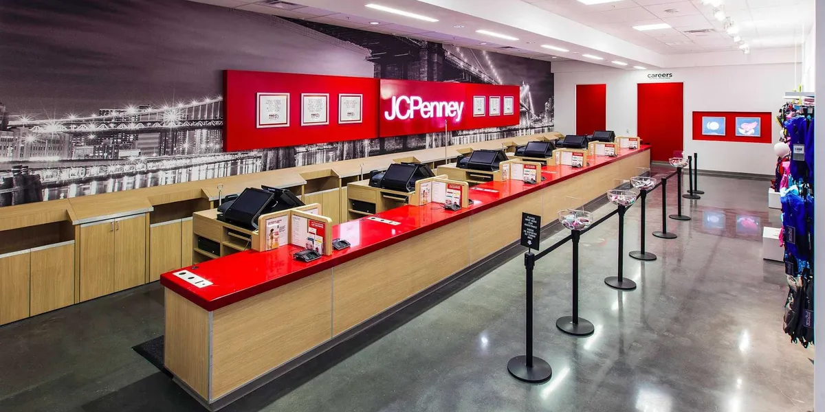 Interior of JCPenney at Pecanland Mall showing merchandise displays, functioning escalators, and open department layout.
