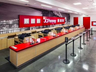 Interior of JCPenney at Pecanland Mall showing merchandise displays, functioning escalators, and open department layout.