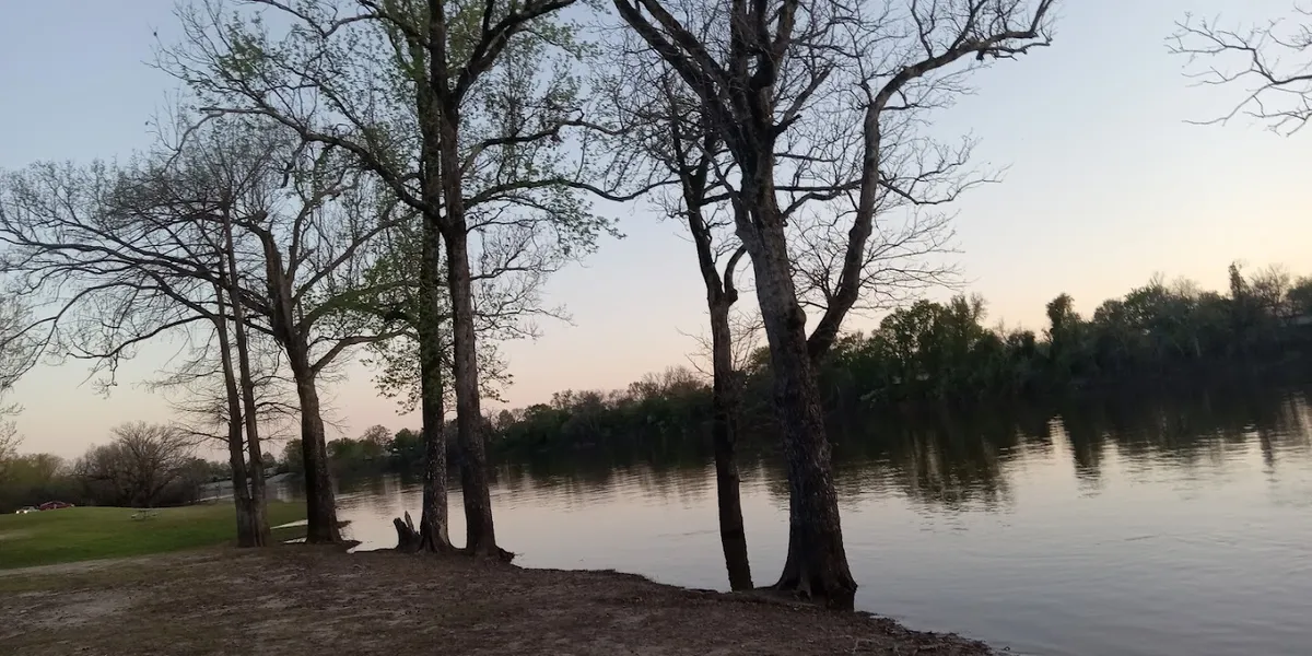 Stone monument on a levee commemorating Jean Louis Alexandre De Breard, with engraved text detailing his historical...