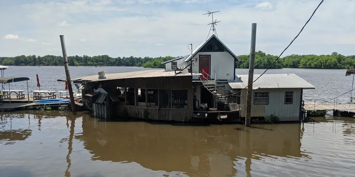 Waterfront RV park with marina docks, wood-fire grill restaurant, and swimming area under open skies at Moon Lake.