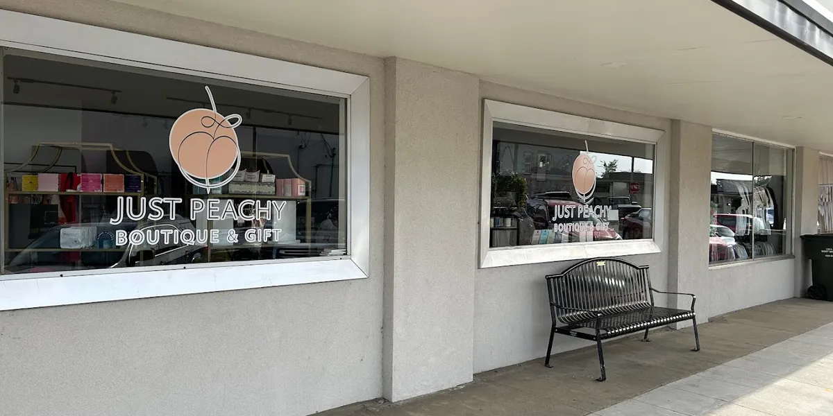 Inviting boutique interior with carefully arranged accessories and fashion items, staffed by friendly owners in a bright...