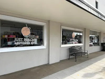 Inviting boutique interior with carefully arranged accessories and fashion items, staffed by friendly owners in a bright...