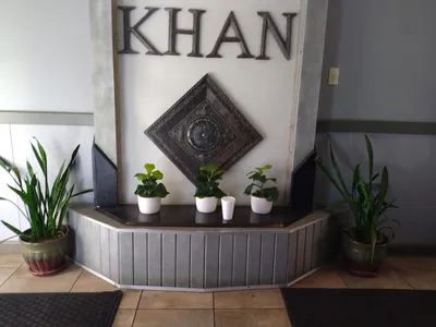 Interior of Khan's Mongolian Grill showing the extensive ingredient bar with multiple protein, vegetable, and sauce...
