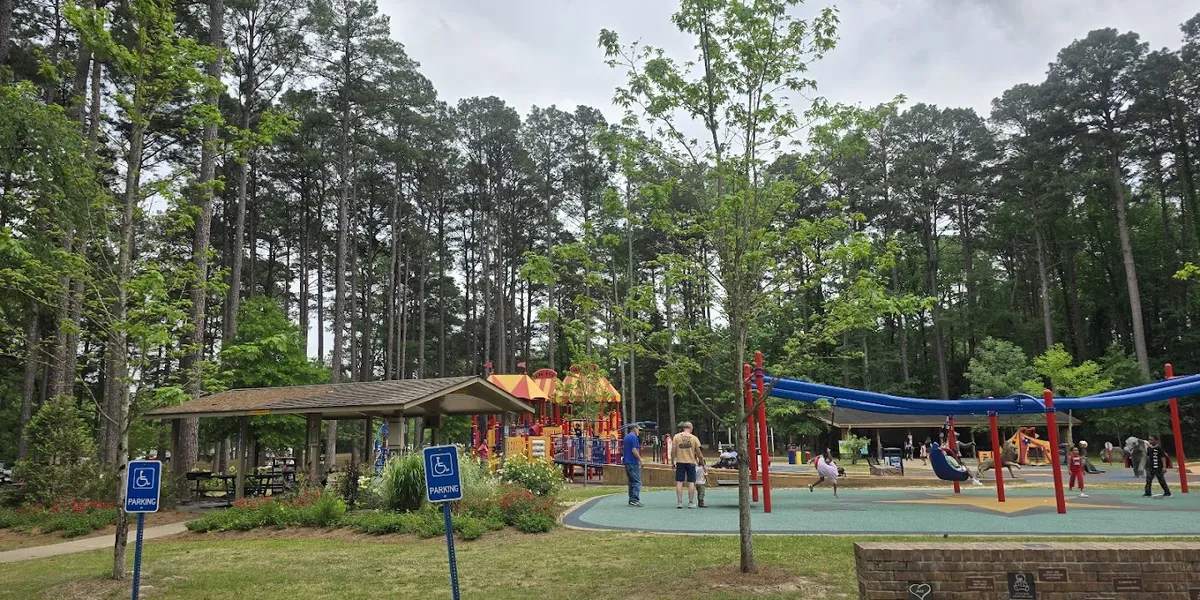 Scenic walking trails wind through Kiroli Park with a sunken garden, fishing pond, and modern playground surrounded by...