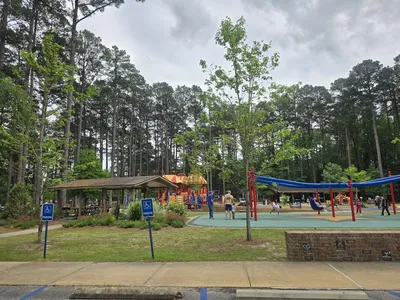 Scenic walking trails wind through Kiroli Park with a sunken garden, fishing pond, and modern playground surrounded by...