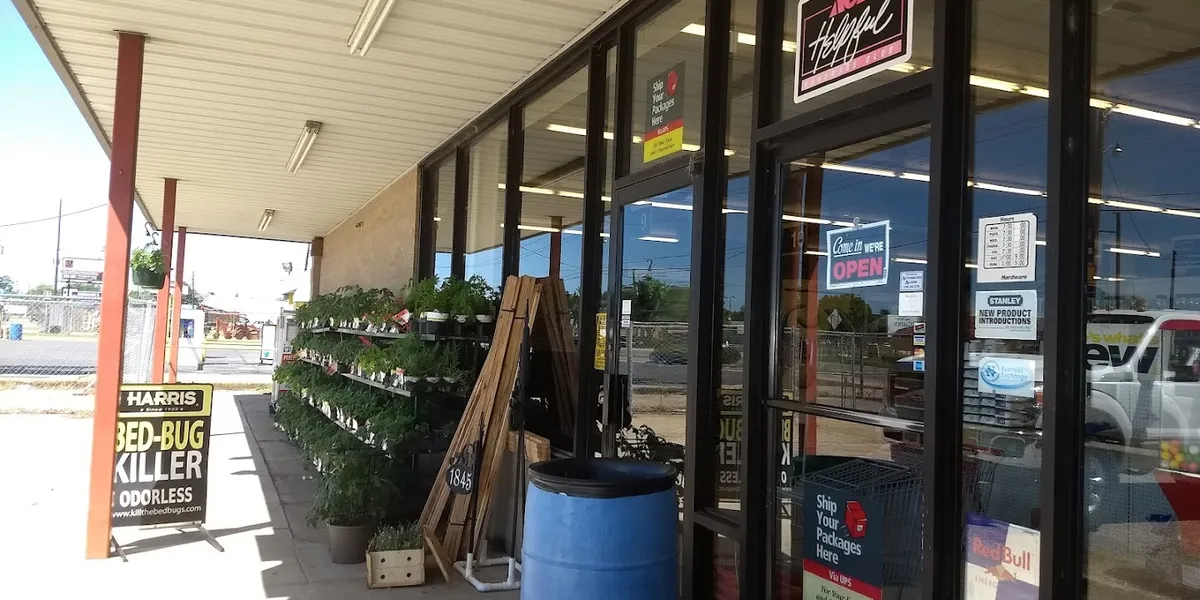 Well-organized hardware store with attentive staff ready to assist customers among aisles of tools, home supplies, and...
