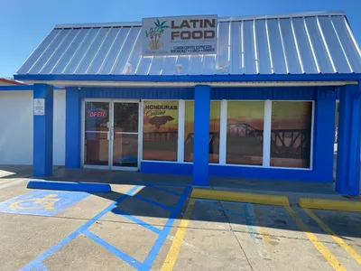 Cozy Honduran cafe with outdoor seating serving traditional Latin dishes and specialty coffee in a warm, family-friendly...