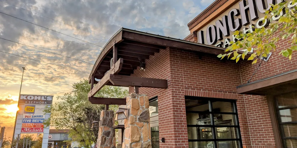 Rustic steakhouse interior with wooden accents and warm lighting, featuring comfortable booth seating and a casual dining...