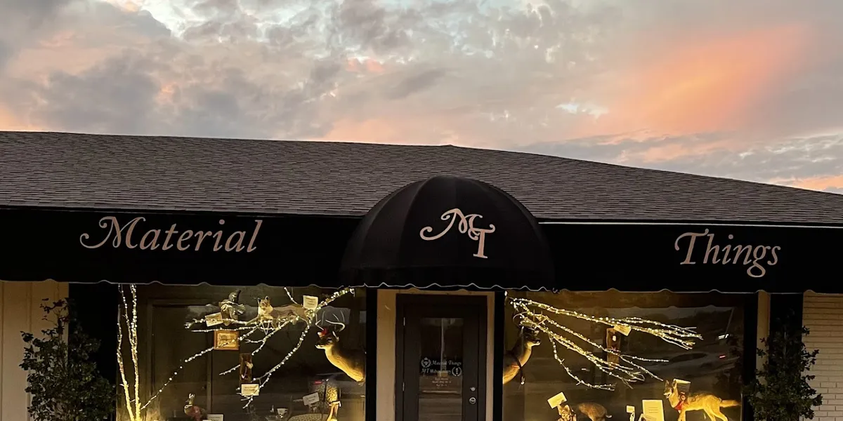 Bright, organized quilt shop displaying colorful fabric bolts, extensive Cosmo floss collection, and unique home decor...