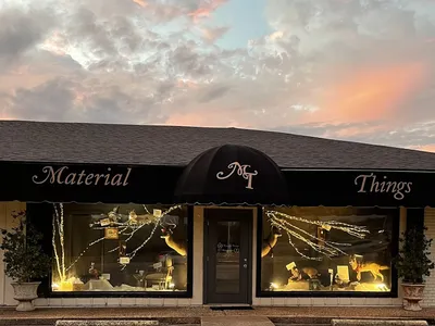 Bright, organized quilt shop displaying colorful fabric bolts, extensive Cosmo floss collection, and unique home decor...