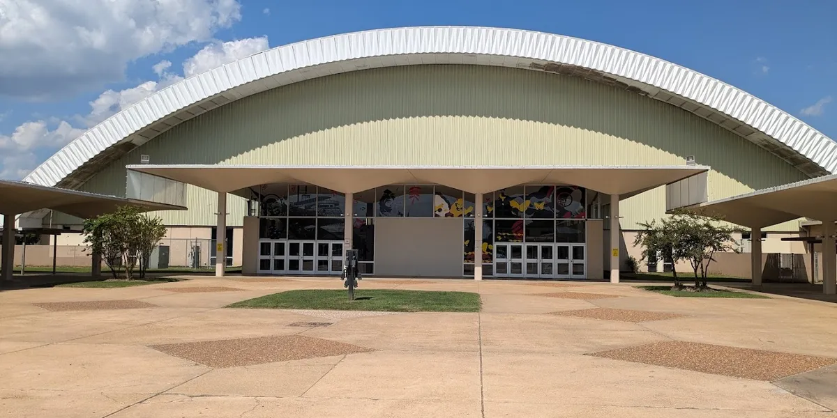 Multi-purpose Monroe Civic Center arena with hockey rink configuration, tiered seating, and southwest-facing plaza...