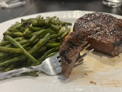 Elegant interior of Monroe's restaurant with upscale dining tables, ambient lighting, and sophisticated decor suitable...