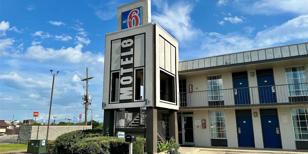 Exterior view of Motel 6 West Monroe showing accessible parking area, room entrances, and Constitution Drive location.