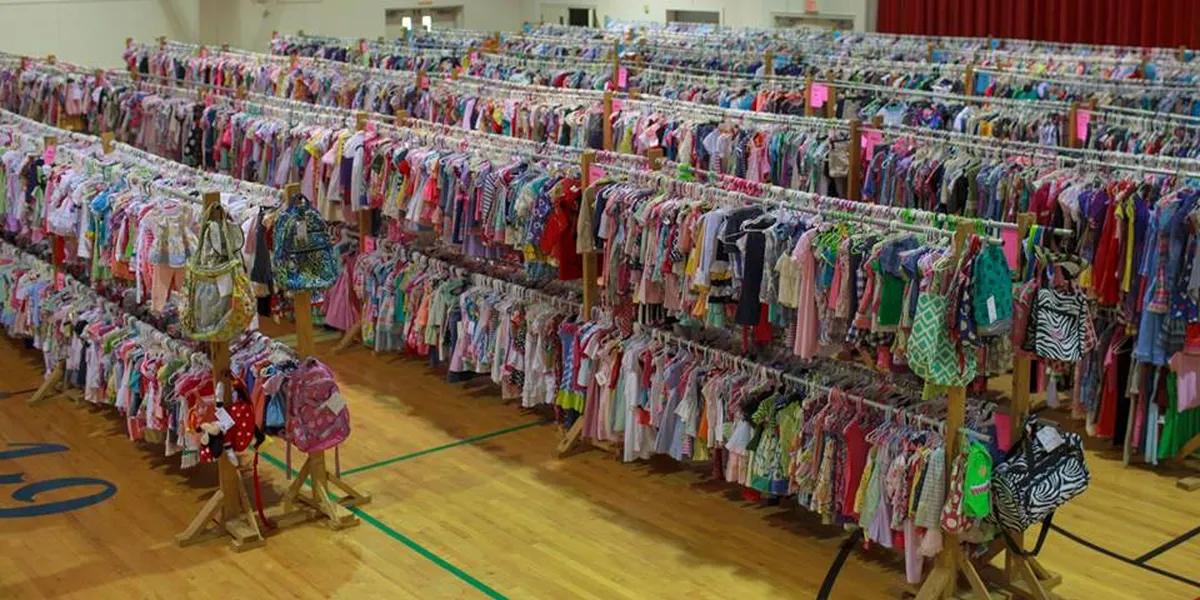 Organized displays of gently-used baby items and toys at Munchkin Market consignment shop with bright lighting and...