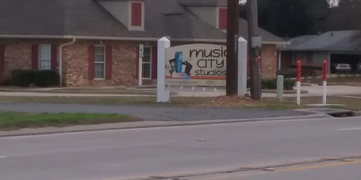 Modern recording studio with professional equipment setup, featuring mixing console and comfortable recording spaces in a...