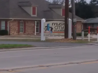 Modern recording studio with professional equipment setup, featuring mixing console and comfortable recording spaces in a...