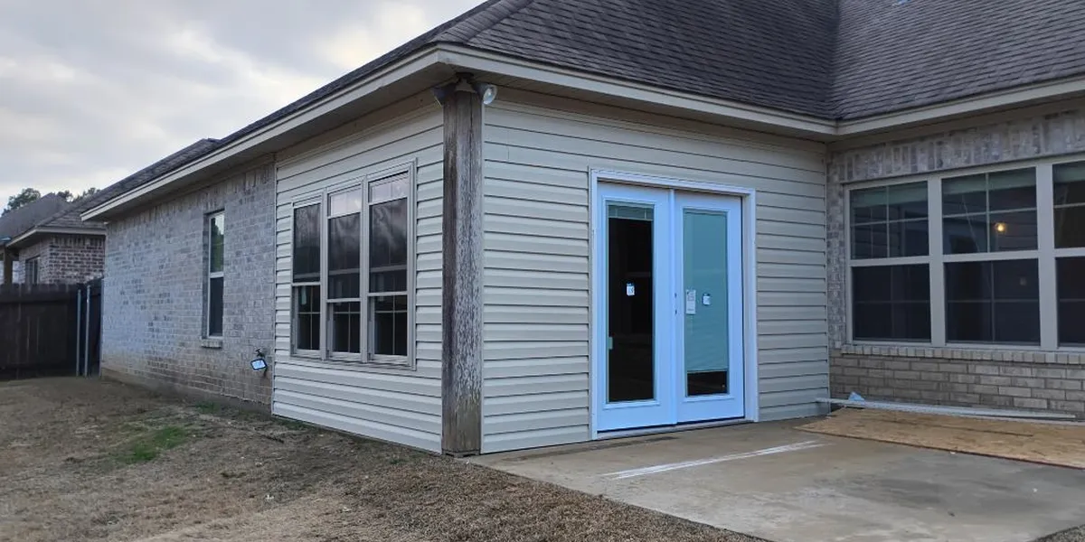 Professional painting crew at work in a West Monroe home renovation, with organized equipment and protected furniture...