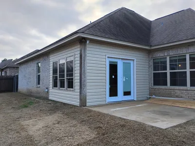Professional painting crew at work in a West Monroe home renovation, with organized equipment and protected furniture...