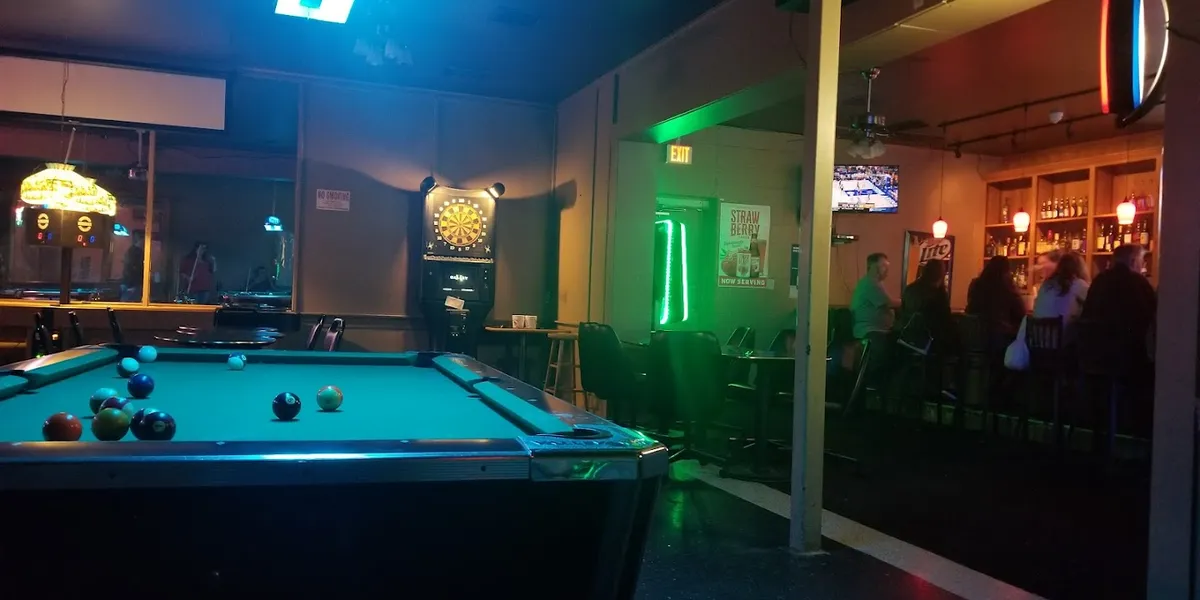 Intimate bar interior at Nell's Airport Lounge with comfortable seating, soft lighting, and a casual atmosphere perfect...