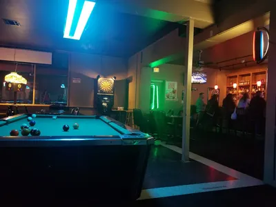 Intimate bar interior at Nell's Airport Lounge with comfortable seating, soft lighting, and a casual atmosphere perfect...