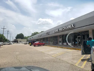 Exterior view of Northgate Shopping Center on Forsythe Avenue featuring traditional mall architecture with multiple...