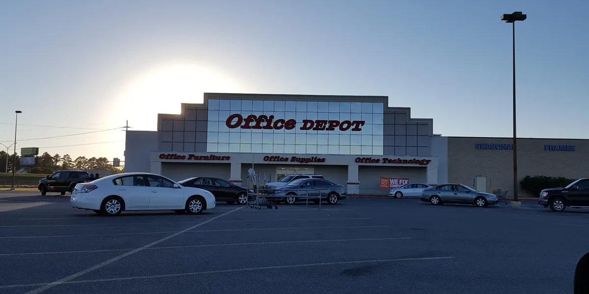 Organized retail space with office supplies, printing station, and document services counter in a bright, well-stocked...