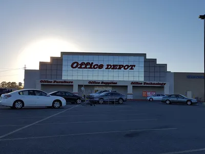 Organized retail space with office supplies, printing station, and document services counter in a bright, well-stocked...