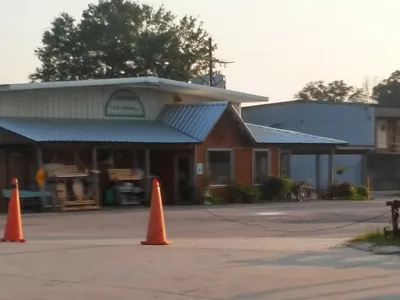 Cozy local hardware store with well-stocked shelves, garden center featuring healthy plants, and display area with white...