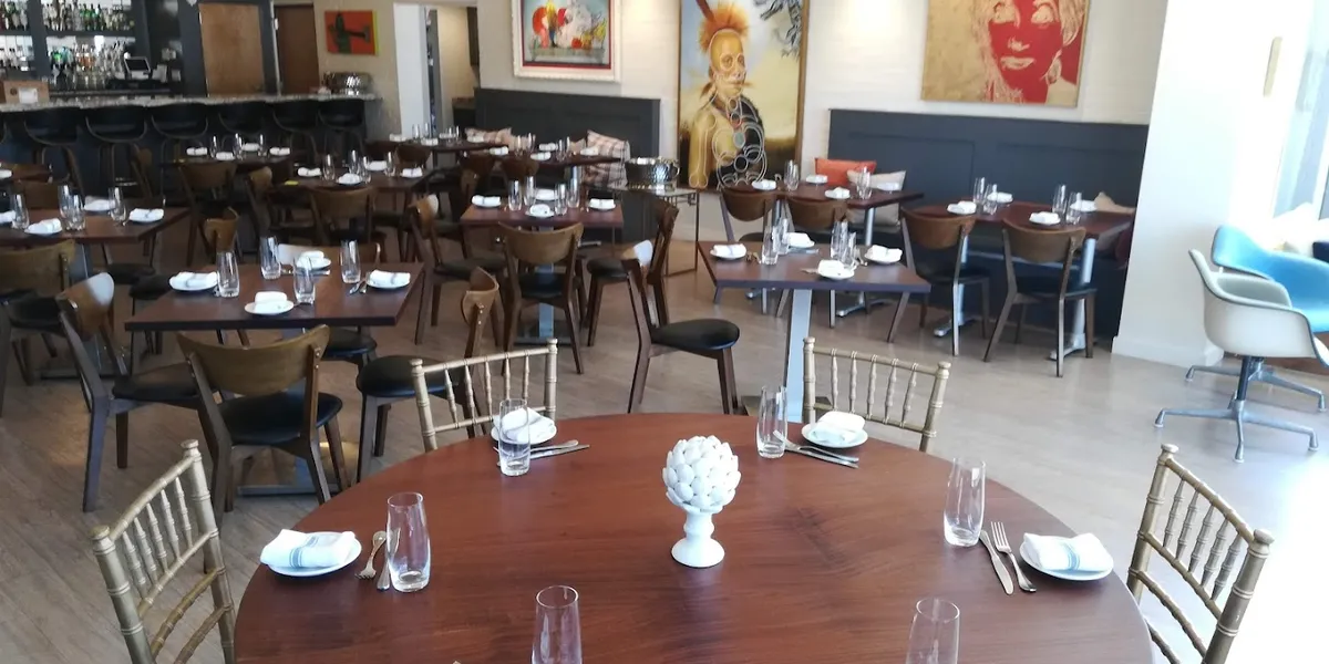 Elegant dining space with outdoor fire-pit seating at Parish Restaurant, where well-plated seasonal dishes complement the...