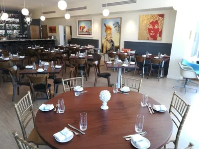 Elegant dining space with outdoor fire-pit seating at Parish Restaurant, where well-plated seasonal dishes complement the...