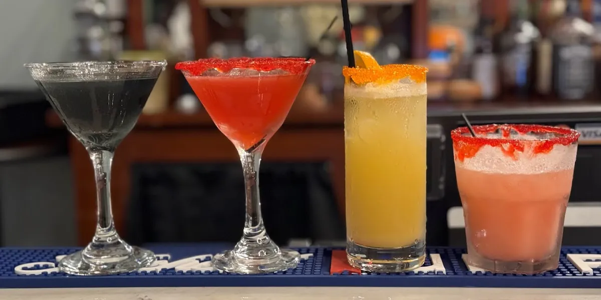 Intimate bar space with mood lighting, comfortable seating, and a sophisticated atmosphere where bartenders craft...