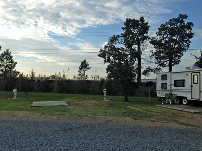 Practical RV park with neat rows of hookup sites, clubhouse building, and minimal landscaping, situated in a quiet area...