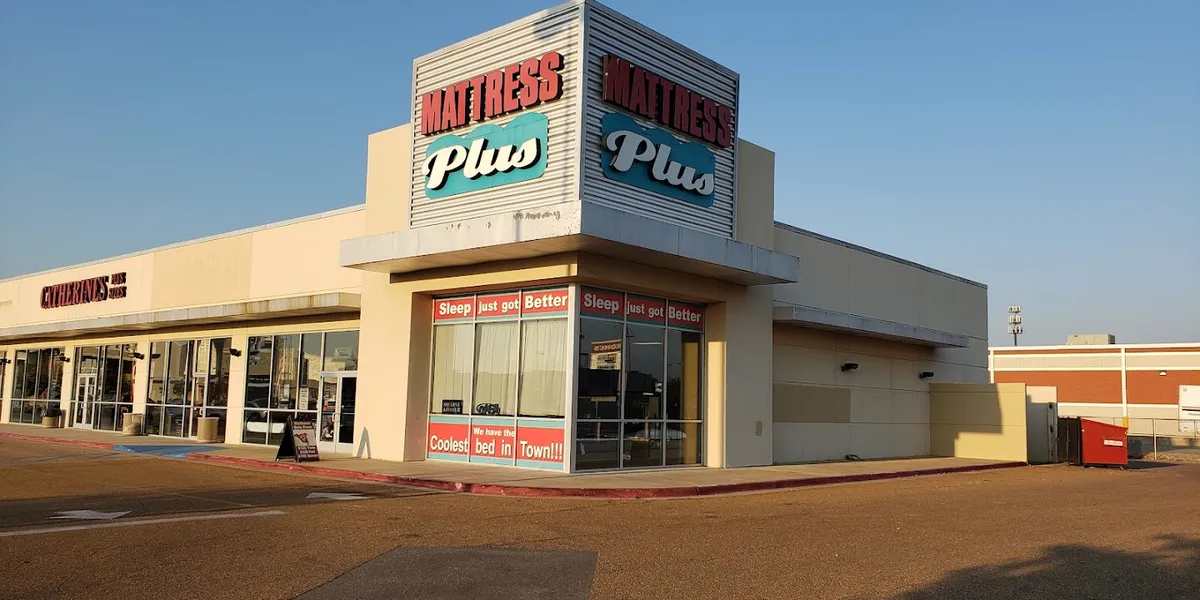 Spacious, well-lit interior of Pecanland Commons mall showing multiple storefronts, wide walking areas, and resting spots...