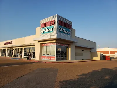 Spacious, well-lit interior of Pecanland Commons mall showing multiple storefronts, wide walking areas, and resting spots...